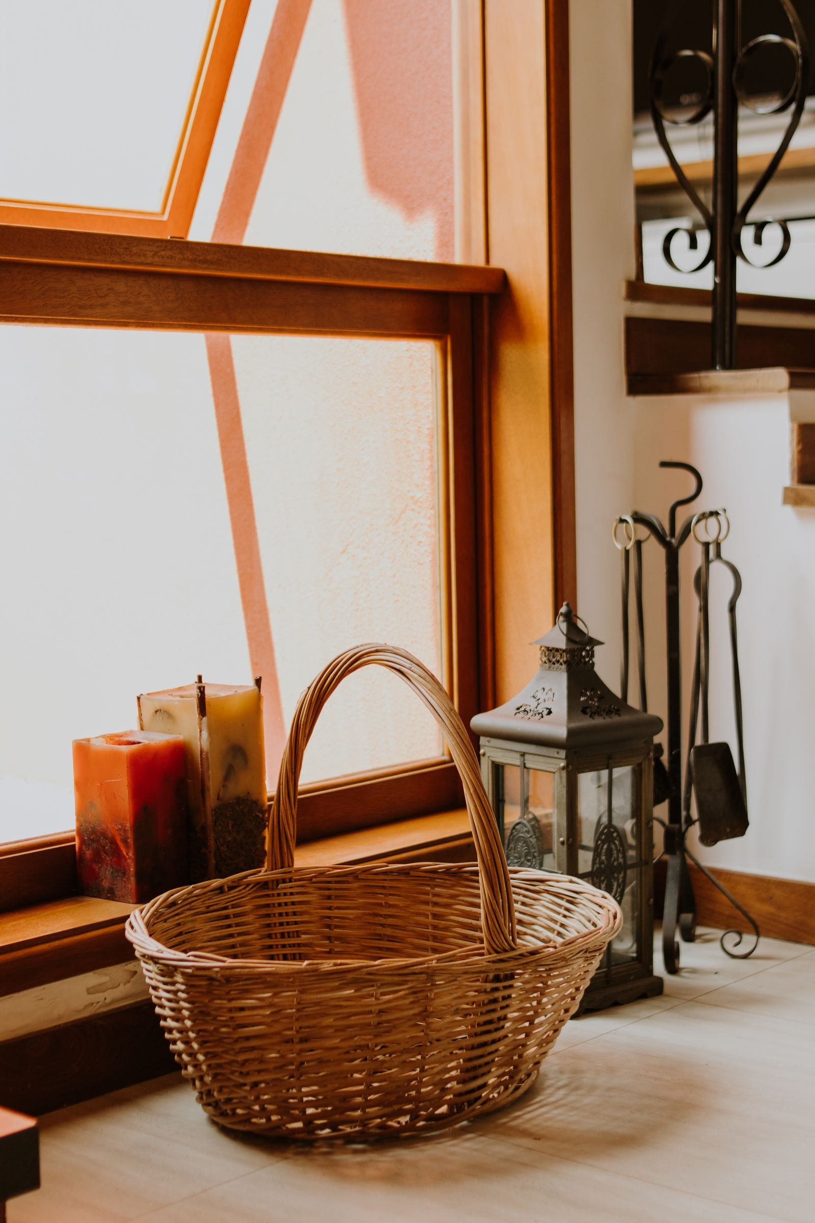 Wicker basket in a sunlit window corner.