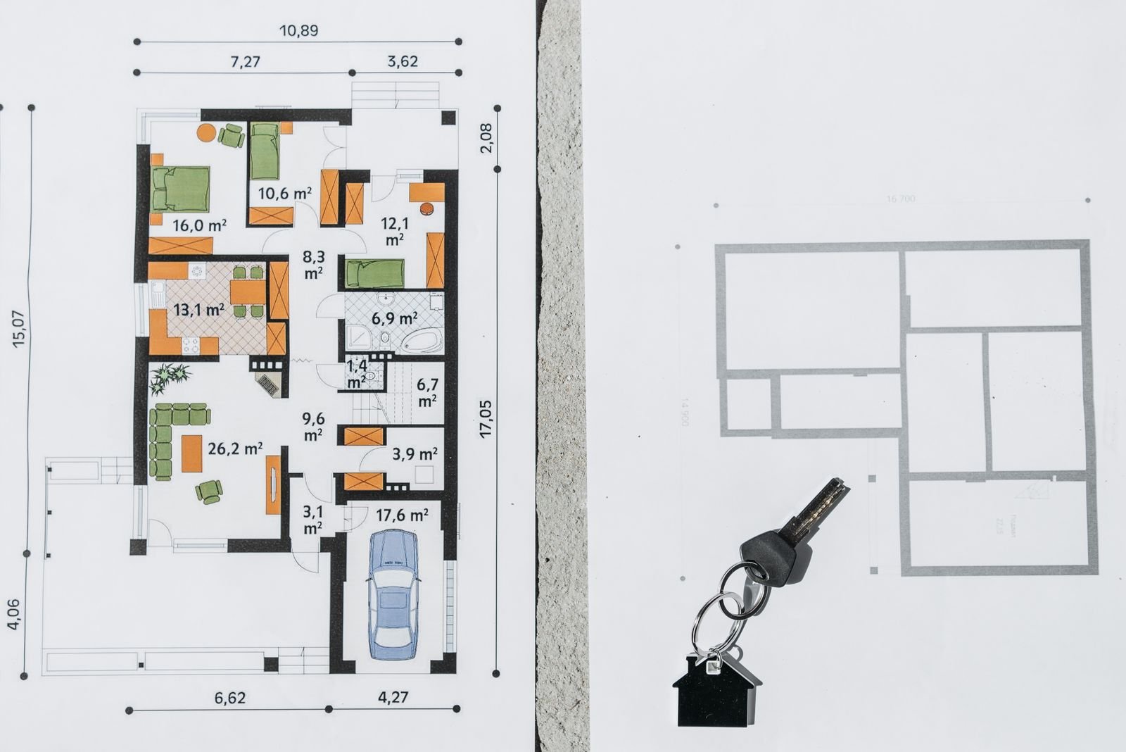 House floor plan laid out on a table with a house key