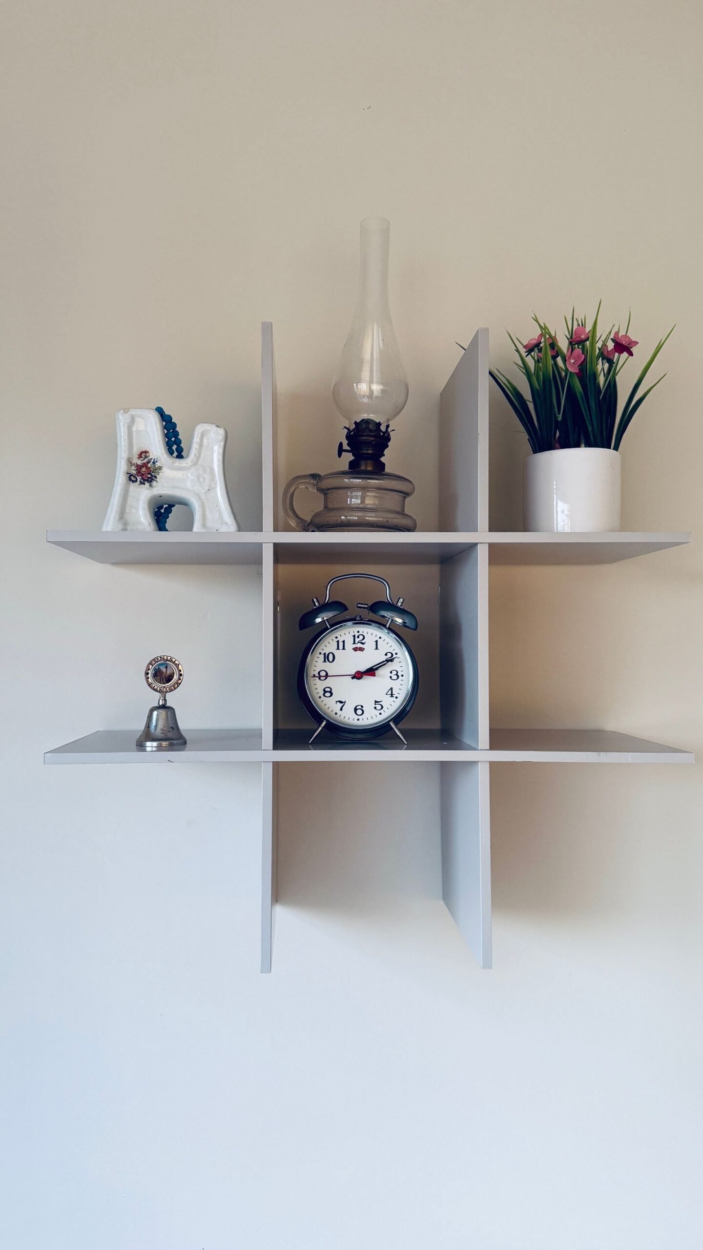 Shelf styled with a vintage clock, a plant and a few treasured decor pieces