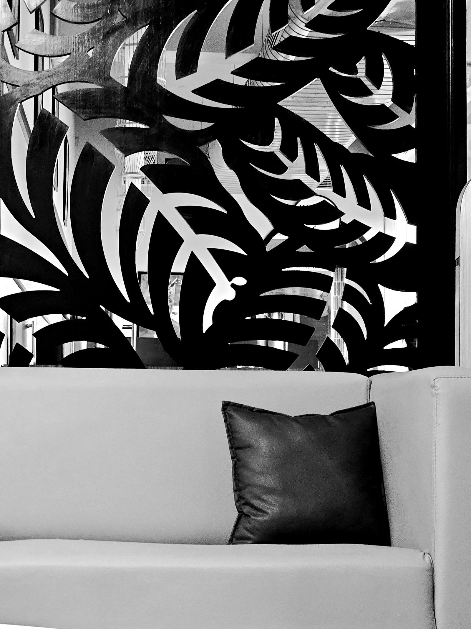 Black and white living room with artwork above a grey sofa