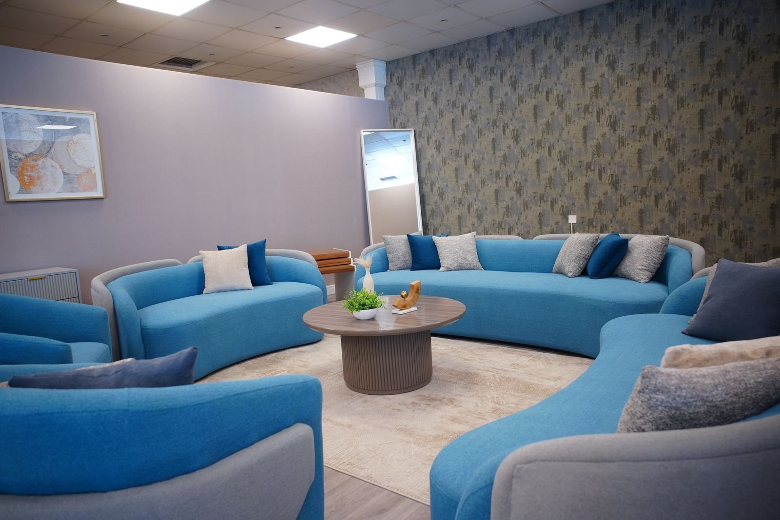 Living room with blue sofas arranged together to guide the eye across the space