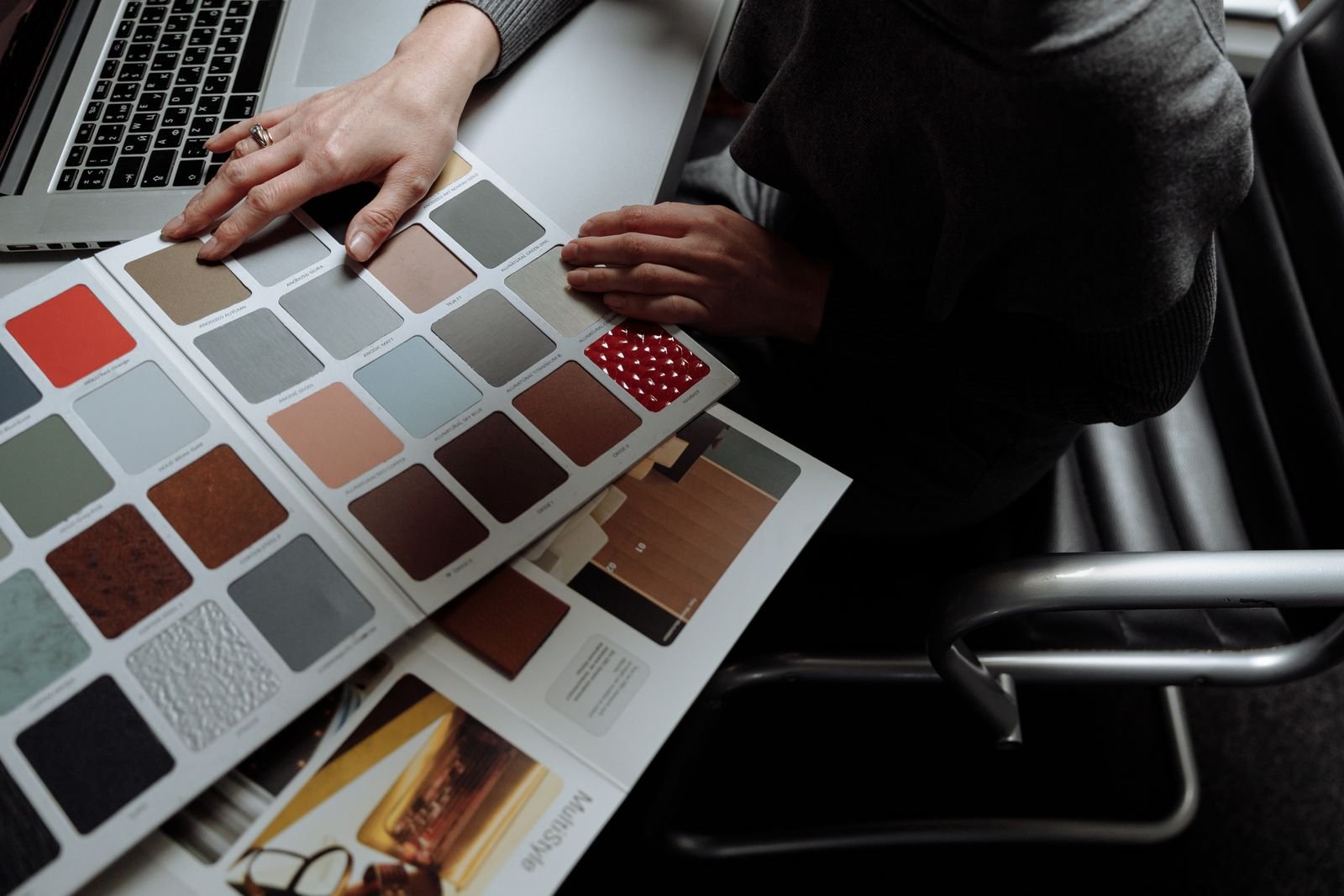 Color swatches and a laptop on a desk for planning a room design