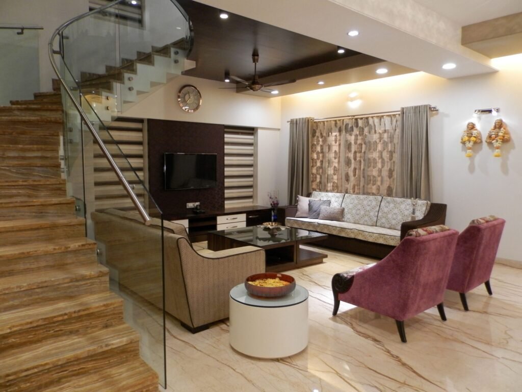 Elegant living room with stylish furniture, marble stairs, and modern decor.