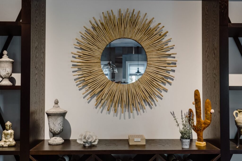 Contemporary living room featuring a unique sunburst mirror and chic decor accents.